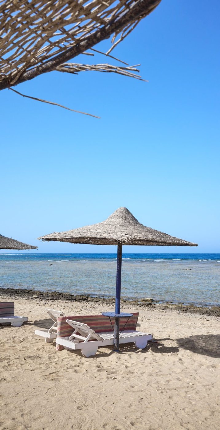 Beautiful sandy beach with sun loungers and umbrellas, Marsa Alam region, Egypt.